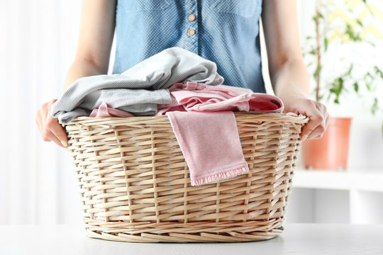 Woman Holding Wicker Basket In Laundry