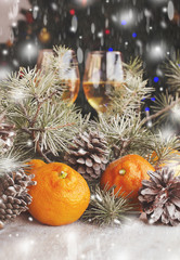 Christmas balls with fir branches and glasses of champagne