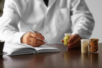 Male doctor with medical recipe book. Herbal medicine concept