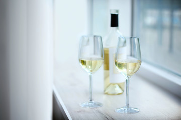 Glasses of wine on windowsill closeup
