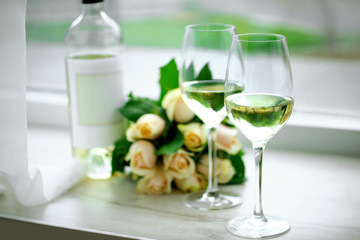 Gentle composition of romantic date with wine and flowers