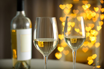 Glasses of wine on romantic blurred background
