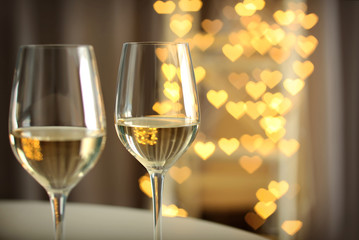 Glasses of wine on romantic blurred background