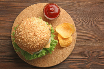 Fresh cheeseburger on wooden background