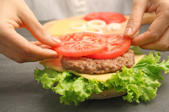 Female hands making fresh hamburger, closeup