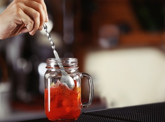 Woman hands making cocktail on bar counter