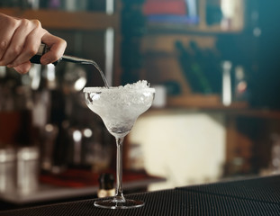 Woman hands making cocktail on bar counter