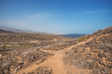 Fototapeta na wymiar Path in scenic volcanic landscape in south Tenerife island, Canary islands, Spain.