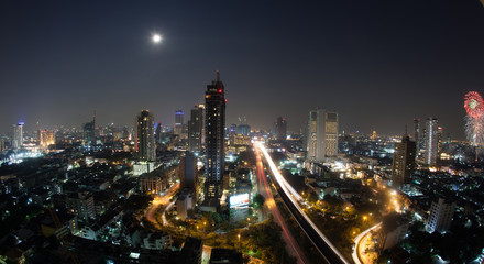 Fototapeta premium Night cityscape of Bangkok, the capital of Thailand. Modern urban architecture, transport traffic and illuminated streets