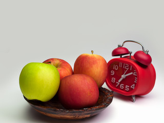 Alarm clock and an apple