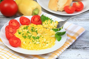Breakfast of scrambled eggs, baguettes  & vegetable