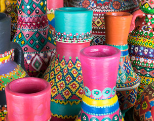 Front view showing a composition of artistic painted colorful handcrafted pottery vases