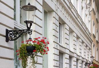 Fototapeta na wymiar Two Streetlamps on a Historic Building's Facade