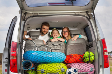 Happy young family ready for a car trip