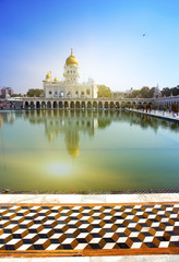 Fototapeta premium The temple of Sikh religion (1783 year) on the bank of a sacred reservoir, India, Delhi..