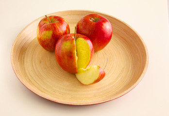 Fototapeta na wymiar Red apples on a wooden plate the table