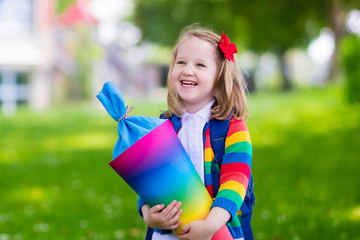 Little child with candy cone on first school day
