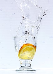 Lemon with water splash and drops isolated on white background