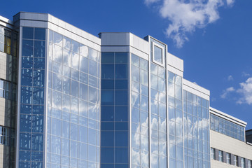 Fototapeta premium A large, modern office building. Clear weather with blue sky.