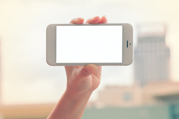 Hand holding smartphone with isolated white screen