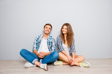happy young smiling couple in love sitting floor