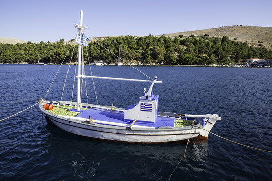 Traditional small fishing boat at sea in Lagkada village, Chios