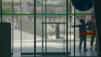 Automatic doors in shopping center, people entering and exiting building