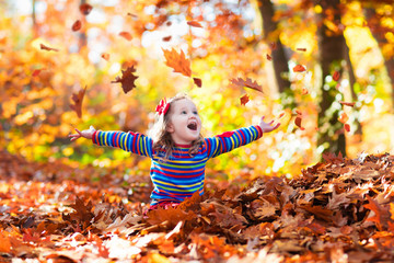 Little girl in autumn park