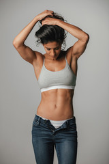 Woman in halter top holds hair with both hands