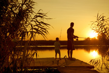 Dad and son fishing on the lake