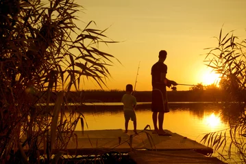 Raamstickers Dad and son fishing on the lake © shoot4pleasure10