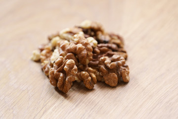 walnut kernels on aok wood table close up