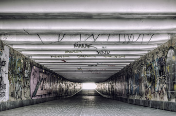 Urban underground tunnel with modern graffiti
