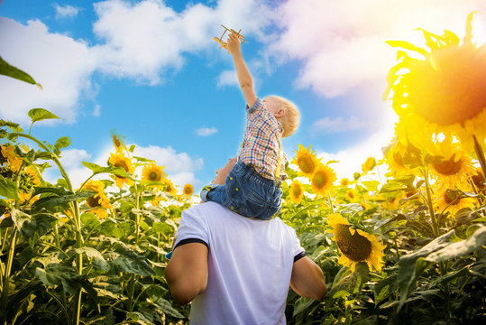 Father with son on the sunflower field