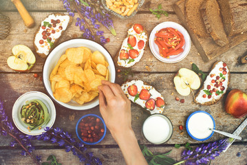 Enjoying dinner with friends. Top view of dinner together while sitting at the rustic wooden table