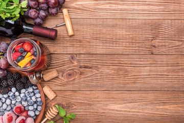 Homemade red wine sangria with fresh berries  on a wooden  table.