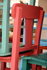 Piled up painted terrace chairs at the beach boulevard
