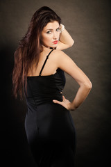 woman in sensual black dress on dark