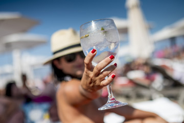 Gin Tonic Girl drinking on the beach