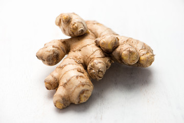 ginger root, isolated on a white cutting board