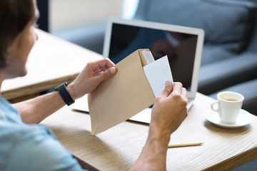 Pleasant man opening a letter