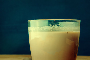 A glass of chocolate on wooden background