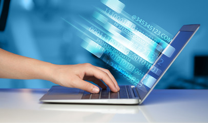 Close up of man typing on laptop computer