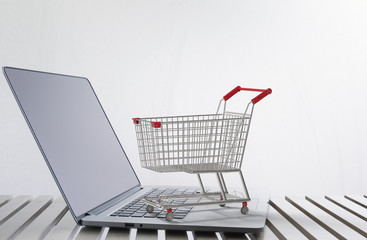 online shopping concept with 3d rendering shopping cart on keyboard