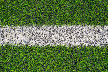 white line paint on  fake grass or artificial grass plastic grass field.