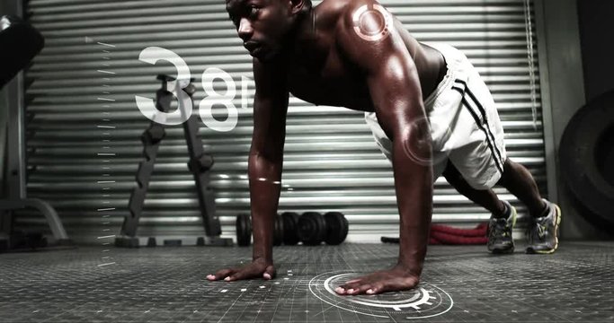 Strong man doing push ups with counter against dark background