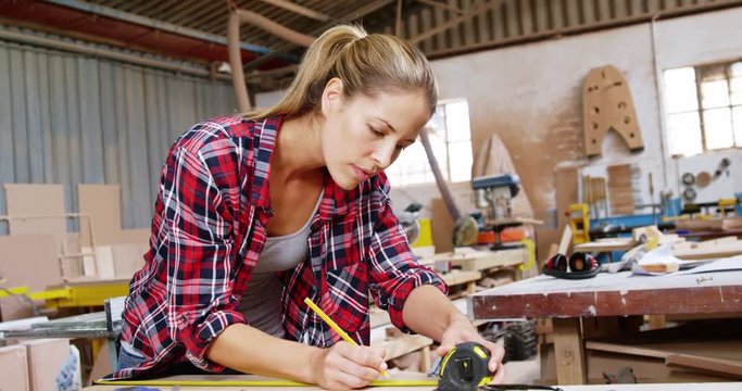 Beautiful carpenter using measure tape