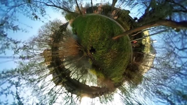 Man Tourist in Green Park Spherical Panorama People Are Riding by Bicycle Walkers Green Fresh Grass Buildings Sunny Day Video For Virtual Reality Cityscape
