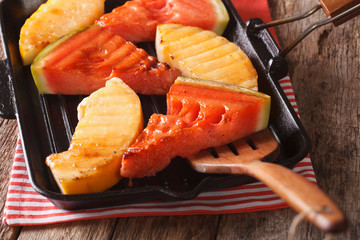 Delicious fresh watermelon and melon in a pan grill close-up. horizontal
