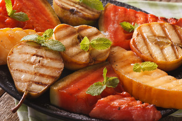 Fruits cooked on the grill watermelon, melon, apple, pear macro. horizontal
